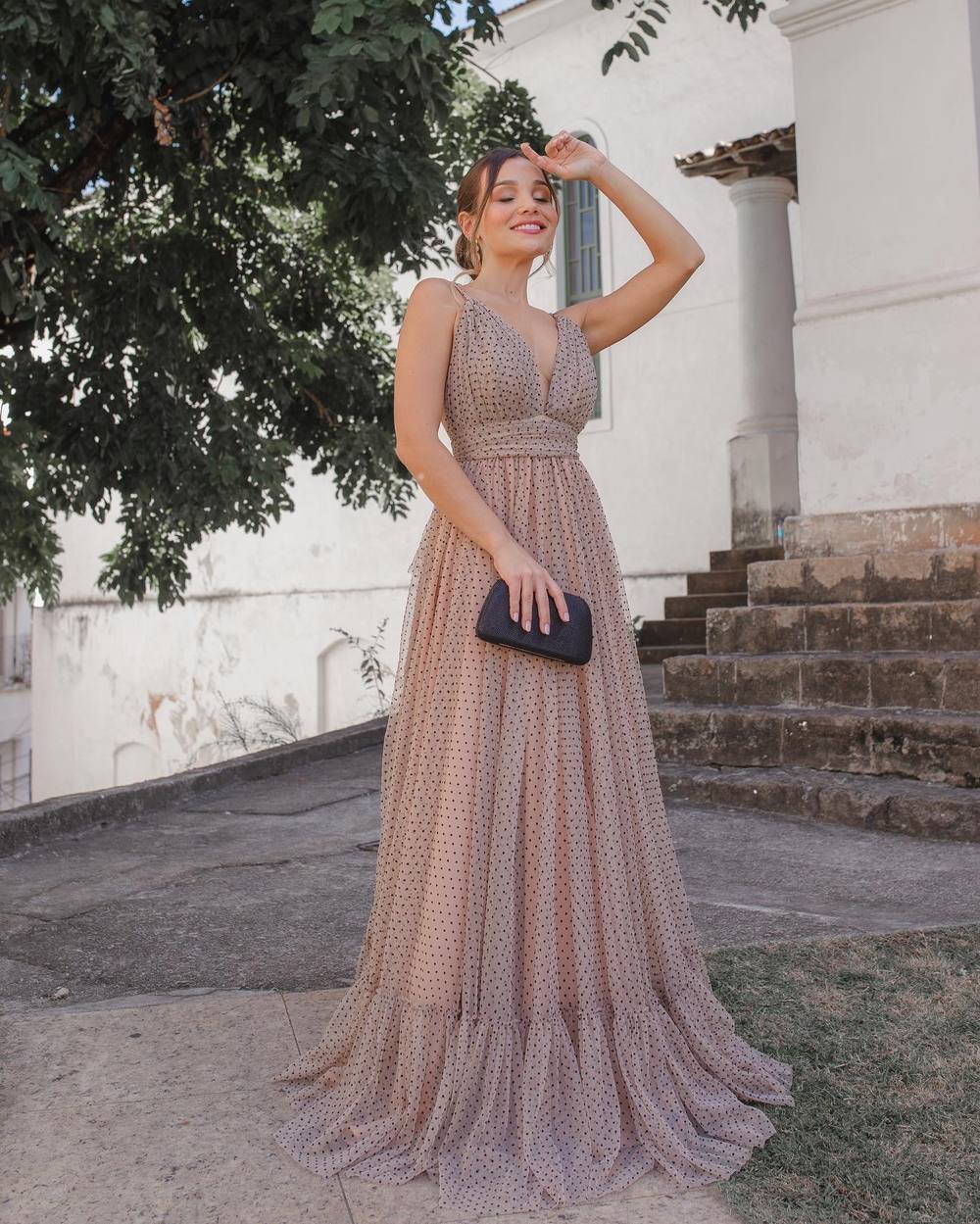 Vestido longo nude com estampa de poás, decote V, alças finas e saia fluida com babado na barra.