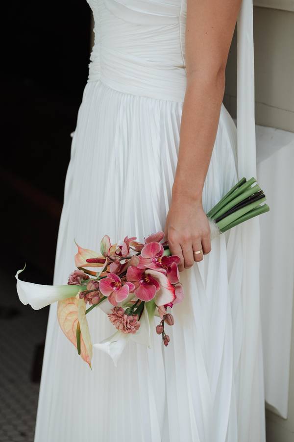 Vestido de noiva branco de frente fechada, detalhe do decote e véu