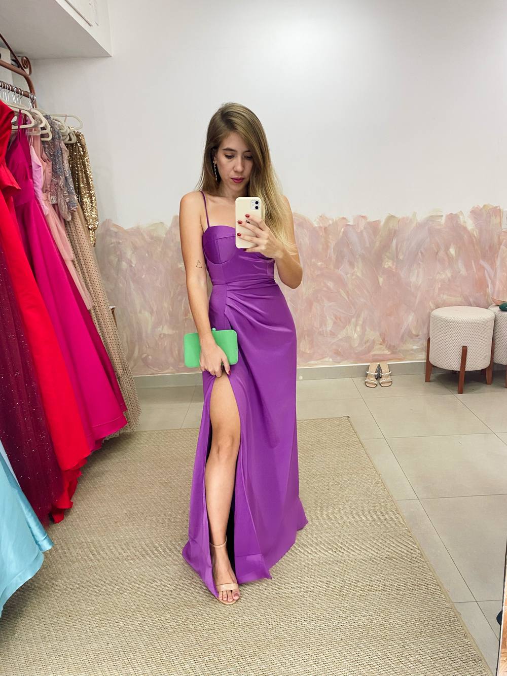 Vestido longo roxo de cetim com alças finas, decote estruturado e saia com fenda lateral.